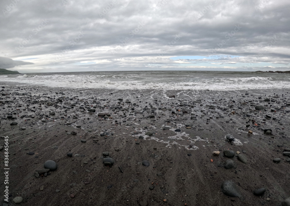 Rocky beach under cloudy sky with scattered leaves in Ballantrae, Ayrshire, Scotland, UK Rocky beach under cloudy sky with scattered leaves in Ballantrae, Ayrshire, Scotland, UK