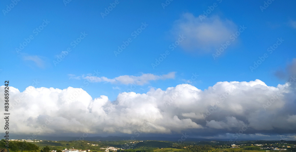 Obraz premium Clear blue sky texture and white fluffy cloud nature background. The sun shines bright in the daytime in summer