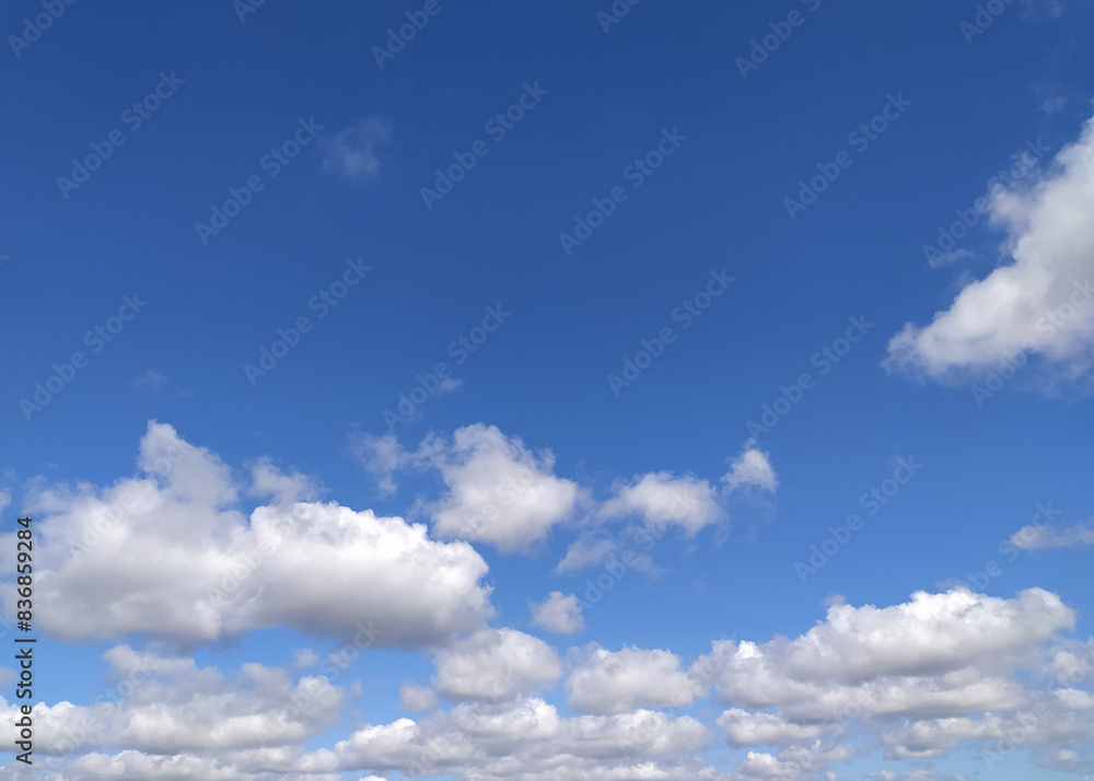 Clear blue sky texture and white fluffy cloud nature background. The sun shines bright in the daytime in summer Clear blue sky texture and white fluffy cloud nature background. The sun shines bright in the daytime in summer