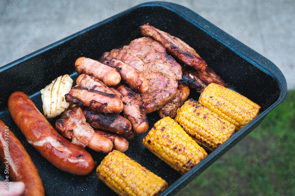 Gegrilltes Fleisch, Würstel, Mais in Bratform Gegrilltes Fleisch, Würstel, Mais in Bratform