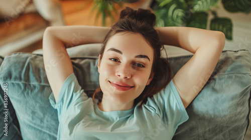 Young Caucasian Woman Laying Back on Comfortable Sofa and Relaxing in Modern Living Room Interior, Embracing Home Lifestyle and Tranquility