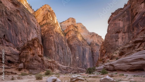 A breathtaking view of the canyon, where high rock formations are illuminated by the golden hues of the setting sun.