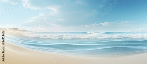 Gentle waves lapping the sandy shore form a tranquil scene with room for text in the image.