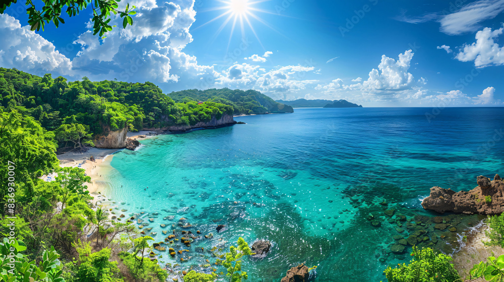 Fototapeta premium Panoramic view of a tropical forest and beach with turquoise waters under a sunny sky