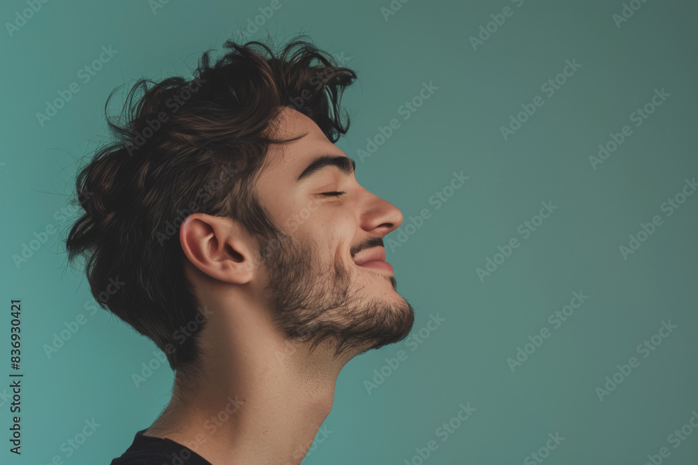 A close up of a man with beard and closed eyes looking to a side A close up of a man with beard and closed eyes looking to a side