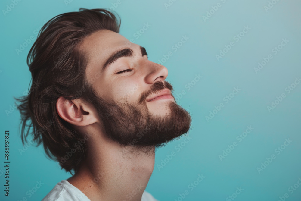 Fototapeta premium A close up of a man with beard and closed eyes looking to a side