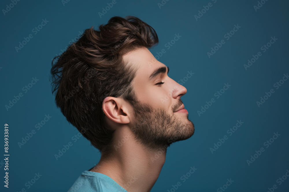 A close up of a man with beard and closed eyes looking to a side A close up of a man with beard and closed eyes looking to a side