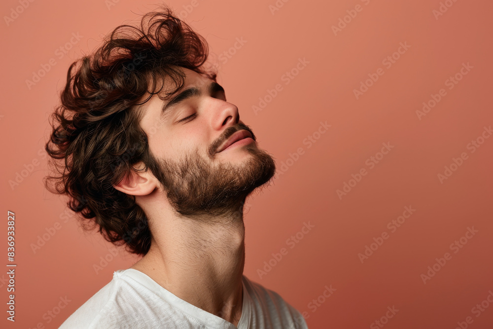 Fototapeta premium A close up of a man with beard and closed eyes looking to a side