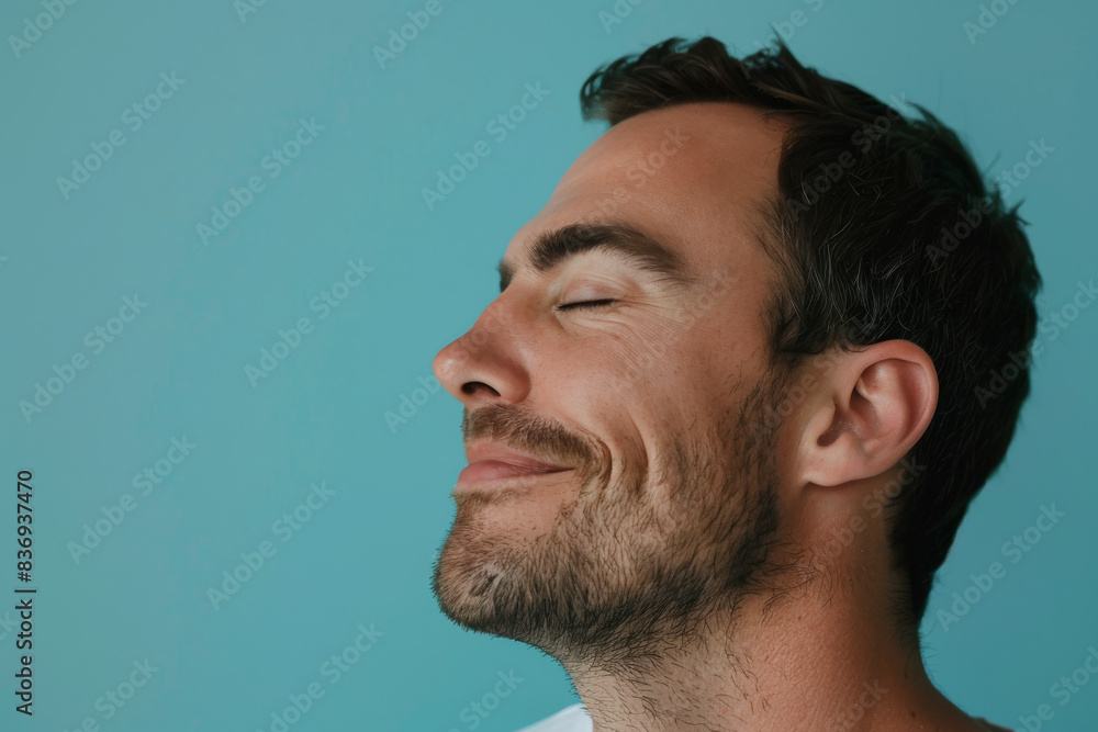 Fototapeta premium A close up of a man with beard and closed eyes looking to a side