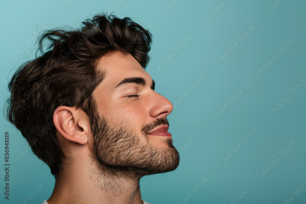 Fototapeta premium A close up of a man with beard and closed eyes looking to a side