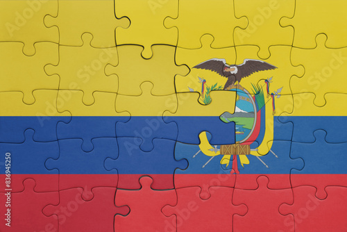puzzle with the colourful national flag of ecuador and flag of colombia .