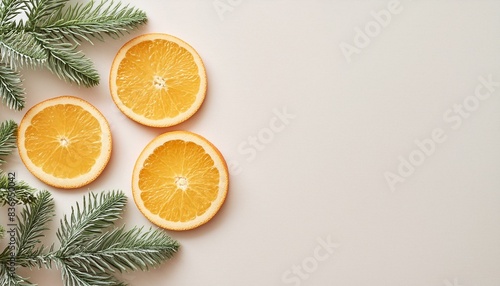 A stylish minimalistic background with fir tree branches and sliced oranges