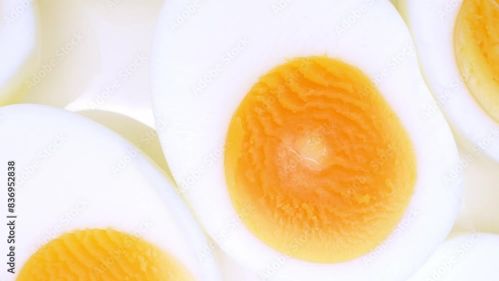In this close-up, halved boiled eggs showcase vibrant yellow yolks nestled within pristine, smooth egg whites. The creamy texture of the yolks contrasts with the firmness of the whites.
In this close-up, halved boiled eggs showcase vibrant yellow yolks nestled within pristine, smooth egg whites. The creamy texture of the yolks contrasts with the firmness of the whites.