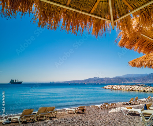 Sunny morning on sandy beach of the Red Sea in Eilat - famous tourist resort ...