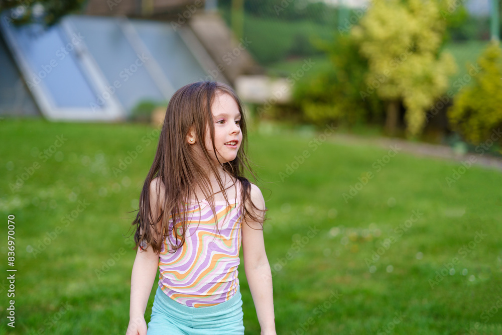 Adorable little girl having fun outdoors on warm and sunny summer day Adorable little girl having fun outdoors on warm and sunny summer day