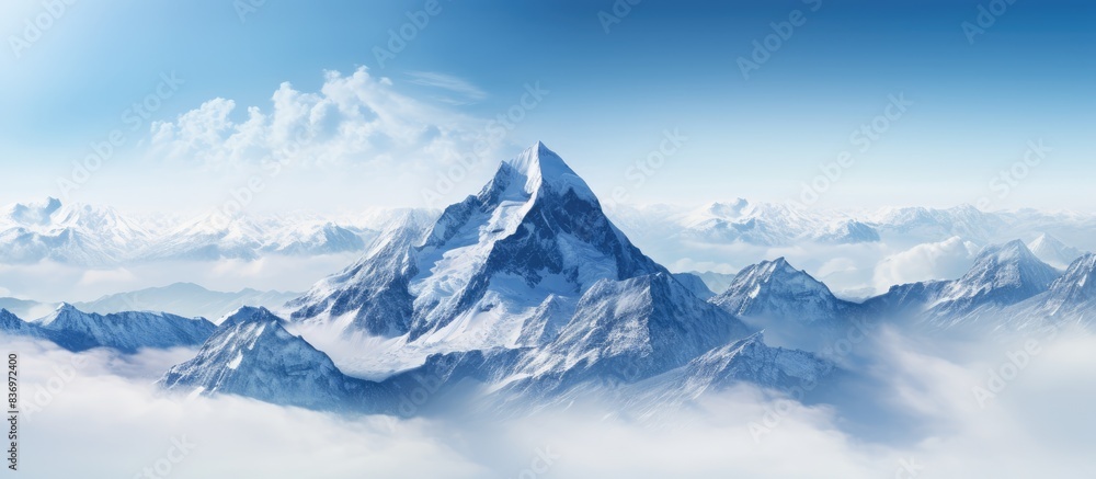 Majestic mountain summit towering over a sea of clouds, perfect for a copy space image. Majestic mountain summit towering over a sea of clouds, perfect for a copy space image.
