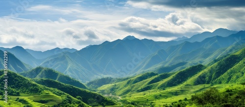 mesmerizing scenery of green mountains with cloudy sky surface. Creative banner. Copyspace image