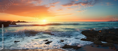 Waves hitting the rocky shore of the beach at sunrise. Creative banner. Copyspace image