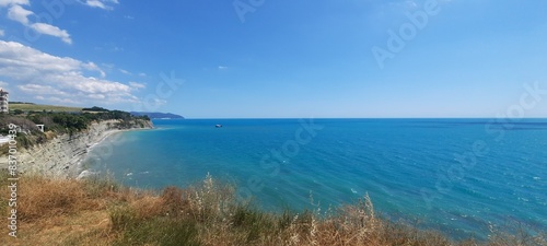 Sea, beach and pebbles, clouds in the sea.