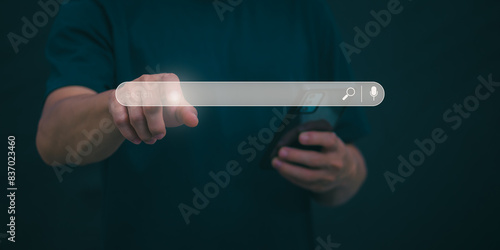 Information search technology, search engine optimization, male hand using a smartphone to search information, using the search bar function on your website