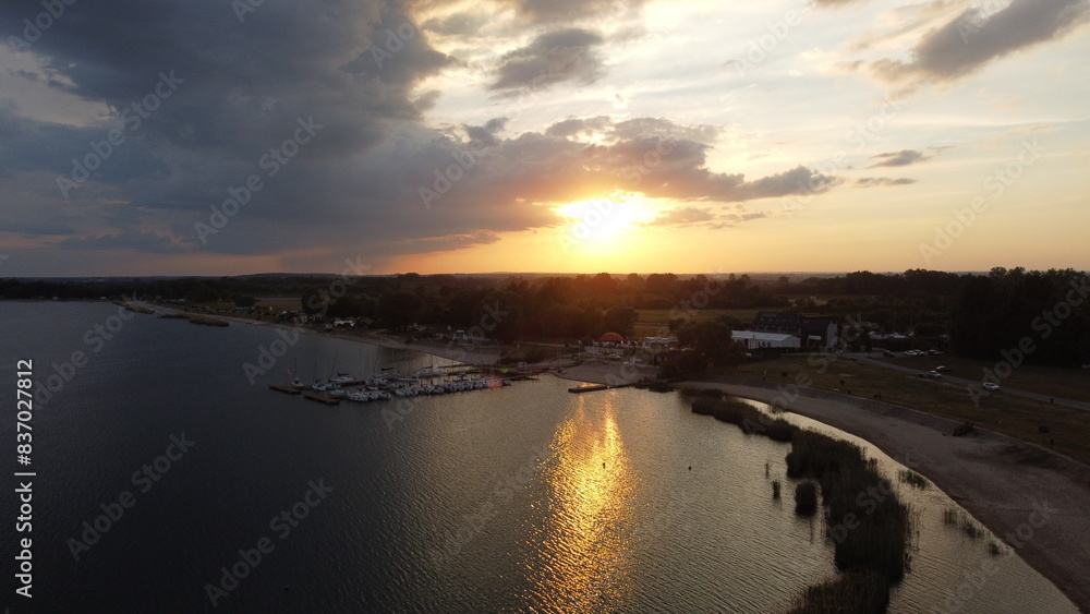 Sunset over the lake water with marina with boats sailboats yachts Sunset over the lake water with marina with boats sailboats yachts