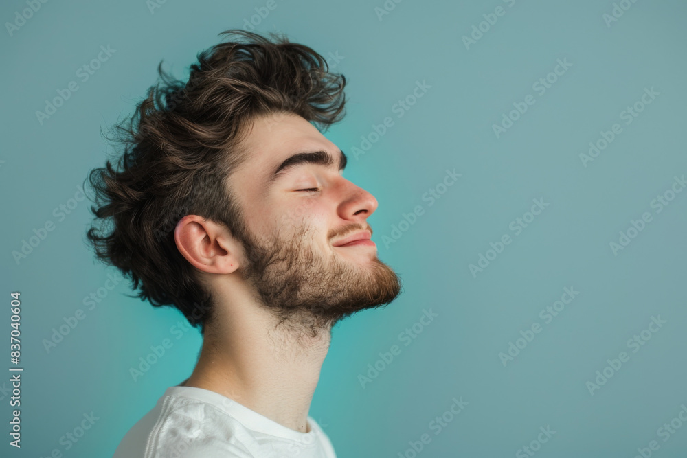 Obraz premium A close up of a man with beard and closed eyes looking to a side