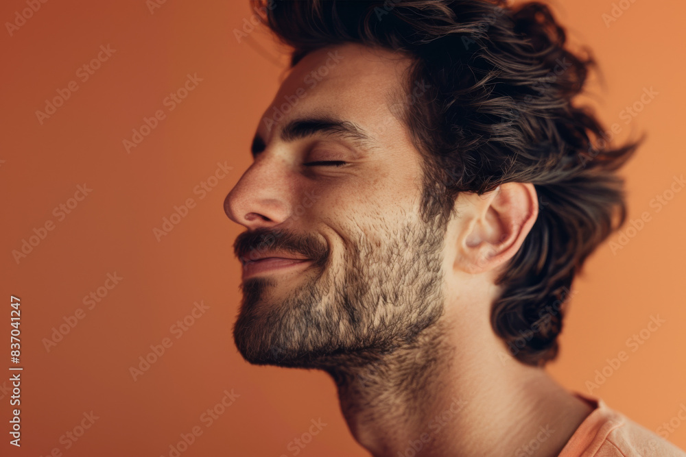 Obraz premium A close up of a man with beard and closed eyes looking to a side