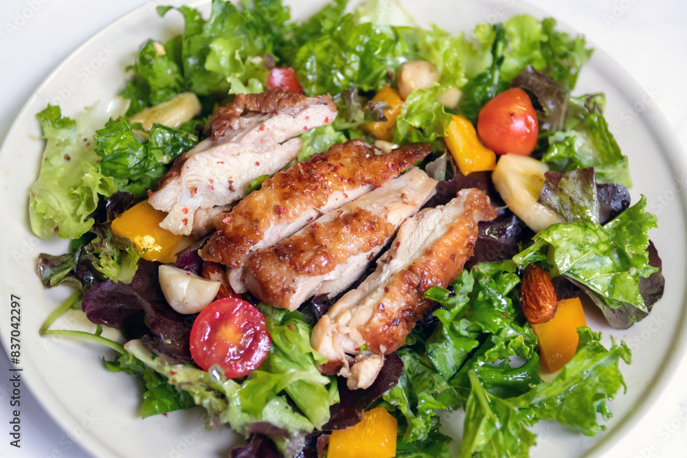 Salad with grilled chicken, cherry tomatoes, lettuce, cucumber and nuts Salad with grilled chicken, cherry tomatoes, lettuce, cucumber and nuts