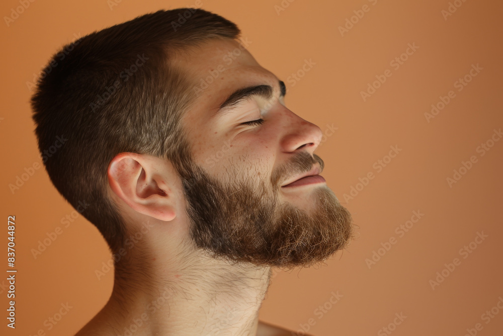 Obraz premium A close up of a man with beard and closed eyes looking to a side