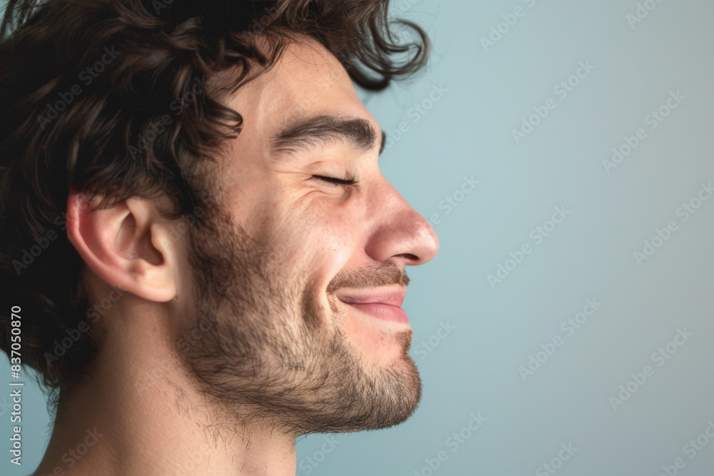 Fototapeta premium A close up of a man with beard and closed eyes looking to a side
