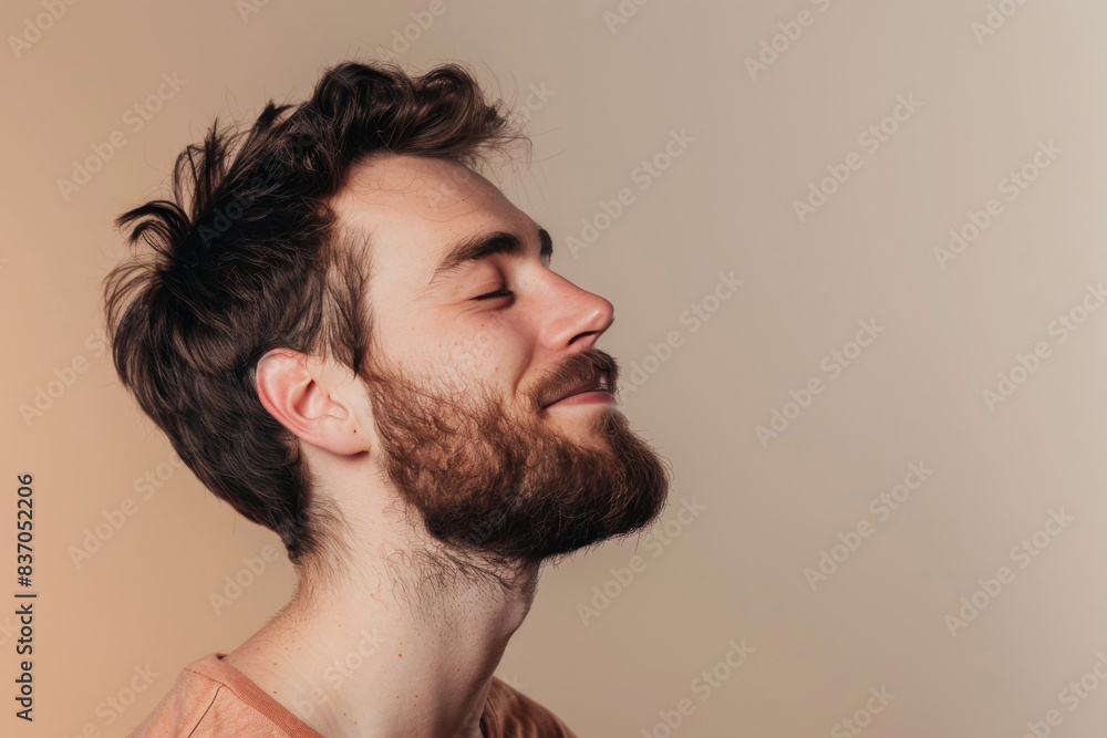 Fototapeta premium A close up of a man with beard and closed eyes looking to a side