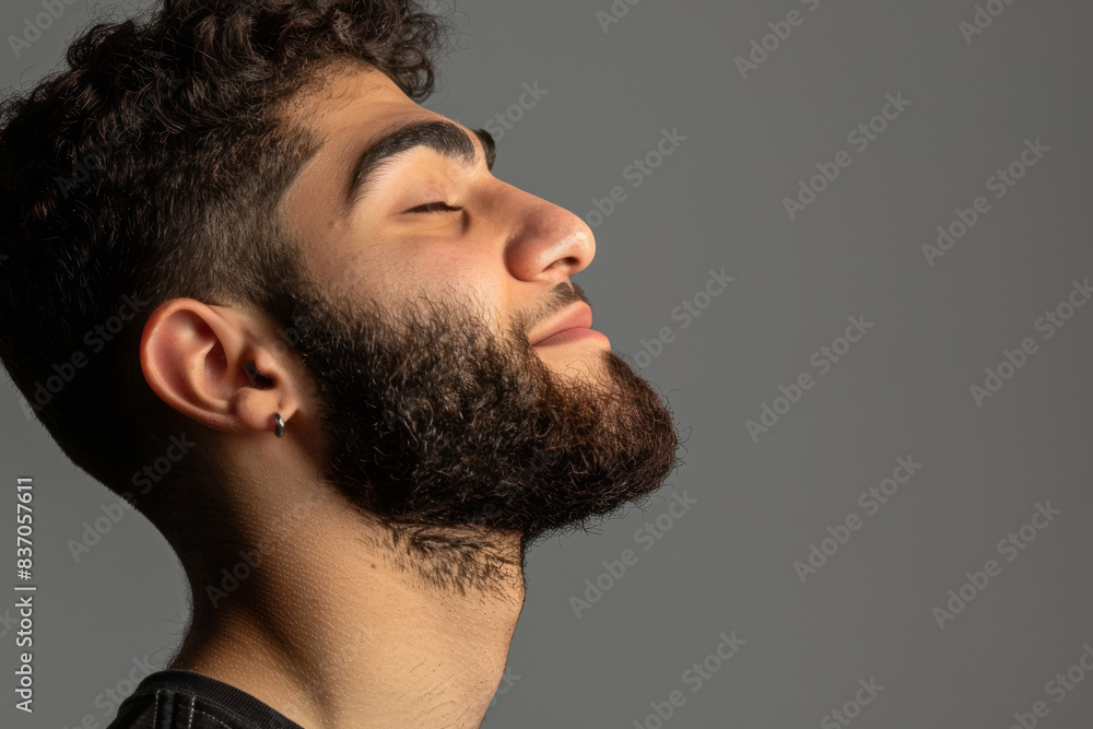 Fototapeta premium A close up of a man with beard and closed eyes looking to a side