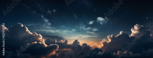 Nighttime clouds hovering gracefully in the sky, their fluffy shapes contrasting beautifully with the backdrop of twinkling stars. photo