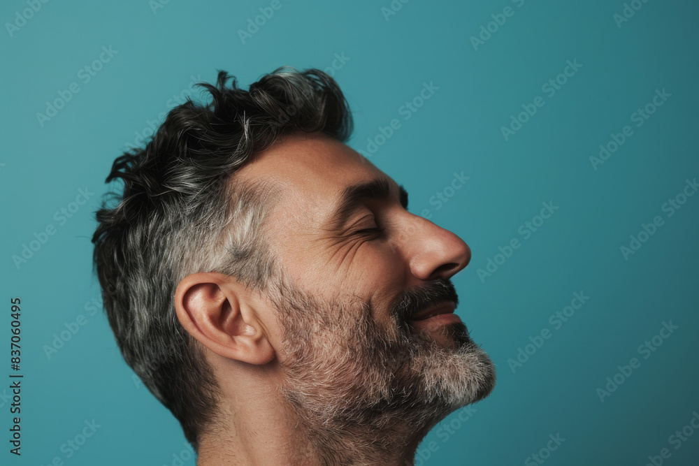Fototapeta premium A close up of a man with beard and closed eyes looking to a side