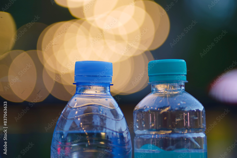 Two clear plastic water bottles with blue caps Two clear plastic water bottles with blue caps