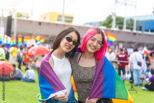 Photography Happy young asian lesbian couple with pride movement LGBT wrapped in rainbow flag for freedom