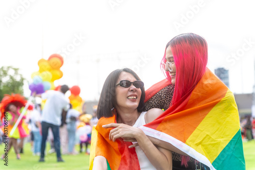 Photography Happy young asian lesbian couple with pride movement LGBT wrapped in rainbow flag for freedom