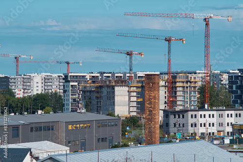 construction site with cranes, apartments