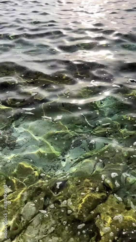 Adriatic sea texture close up. Turquoise water. Stones on the bottom Adriatic sea texture close up. Turquoise water. Stones on the bottom