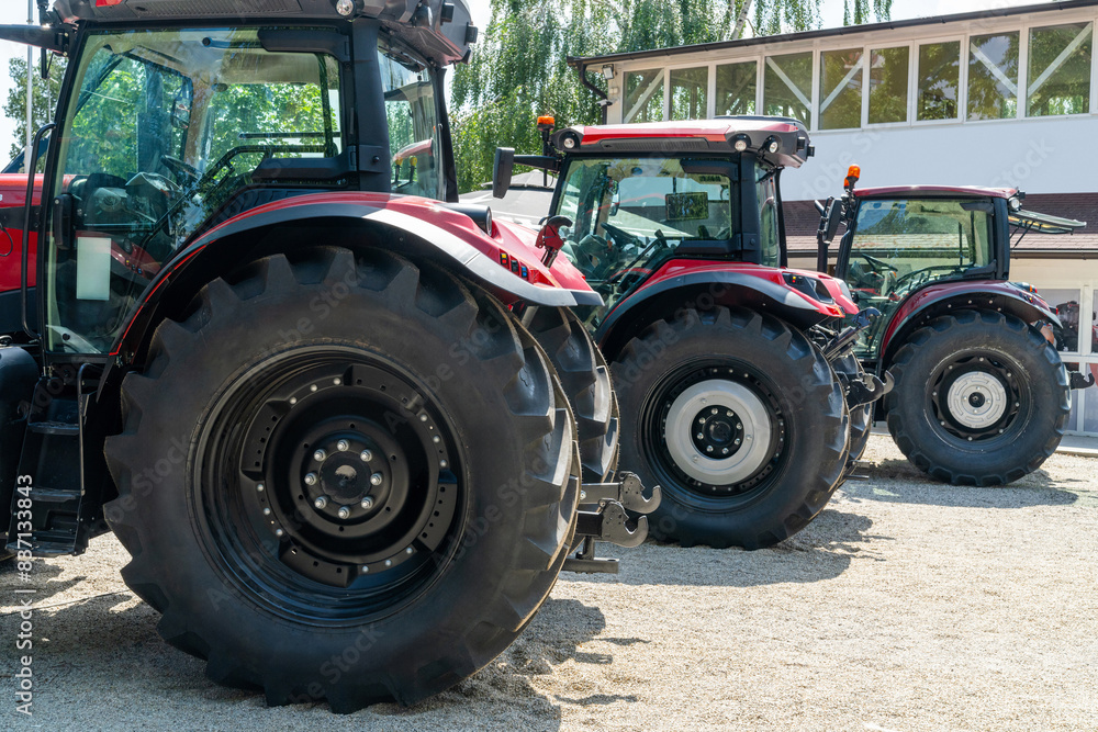 Row of red agricultural tractors for sale. Row of red agricultural tractors for sale.