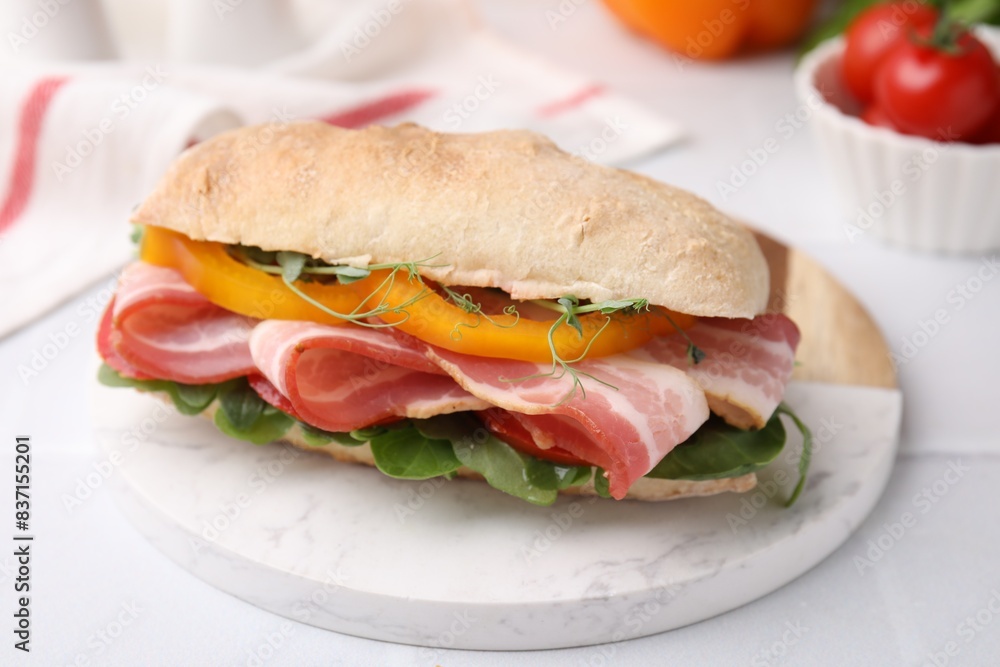 Tasty sandwich with bacon and bell pepper on white table, closeup Tasty sandwich with bacon and bell pepper on white table, closeup