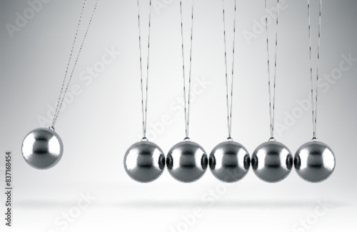Balancing balls Newton's cradle hanging on gray background