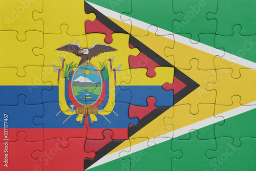 puzzle with the colourful national flag of guyana and flag of ecuador.