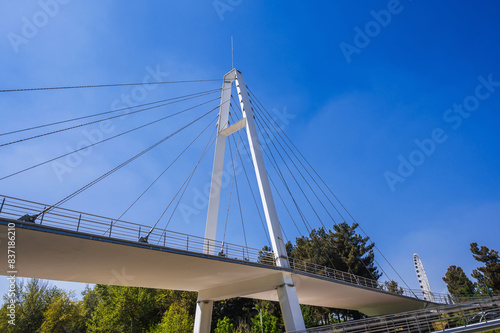 construction of a modern cable-stayed bridge on background of blue sky in Anhor Park in Tashkent in Uzbekistan. Uzbek new pedestrian suspension bridge