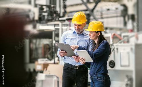 Fotografía Two project managers standing in modern industrial factory