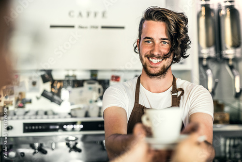 Obraz na plátně Handsome barista working in coffee shop, preparing coffee for customer