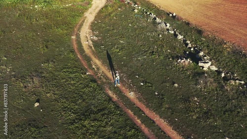 drone view surrounding A person standing alone on a rural road