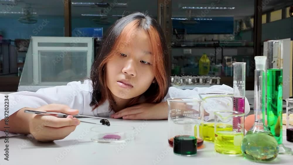Little scientists analyze the composition of a stone or rock sample in Laboratory Little scientists analyze the composition of a stone or rock sample in Laboratory