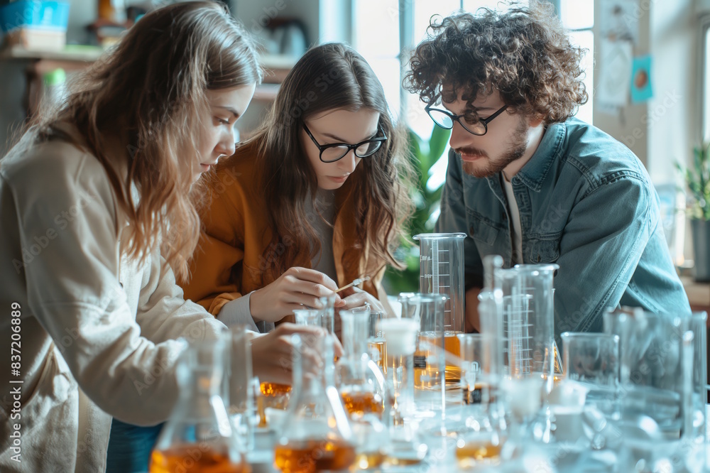 Three young scientists working with lab equipment. Concept of education, research, and focus Three young scientists working with lab equipment. Concept of education, research, and focus