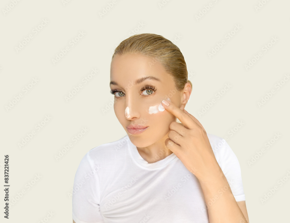 woman applying serum, lotion to her face woman applying serum, lotion to her face